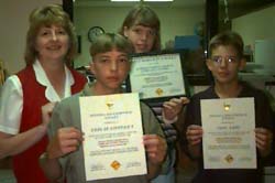 the young Web developers with the certificates they received from the Topeka police