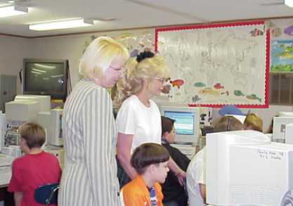 Connie Campbell and Peggy Moates with a number of students who are sitting at computer terminals