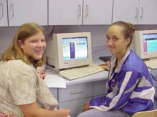 2 students sitting in front of a computer