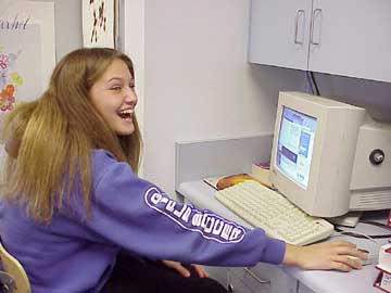 Student at her desk with a computer.