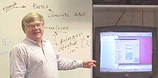 Laporte with a monitor and white-board.